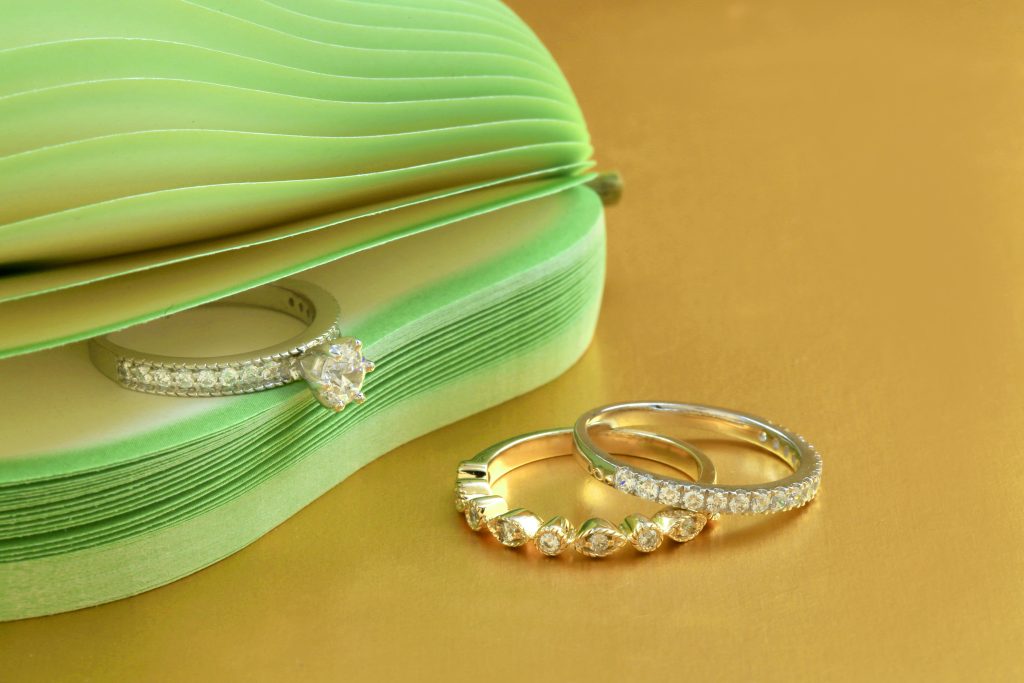 Silver Diamond Studded Rings on Yellow Surface